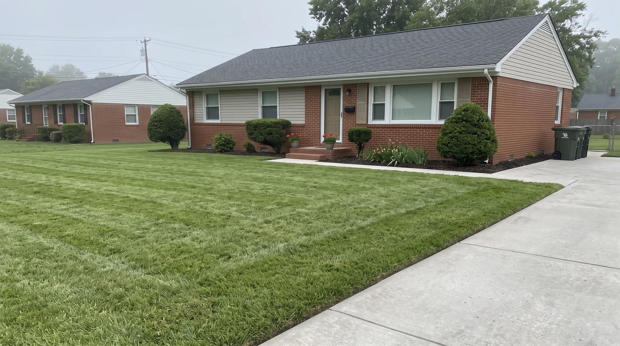 Illustration of a neatly mowed front lawn and edged walkway beside a modest home